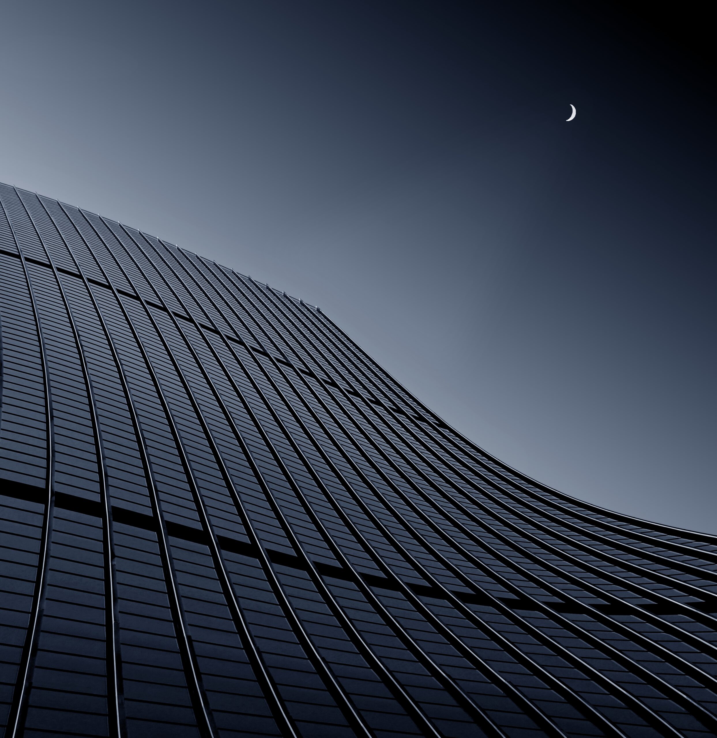 A low angle shot of a modern business building touching the clear sky